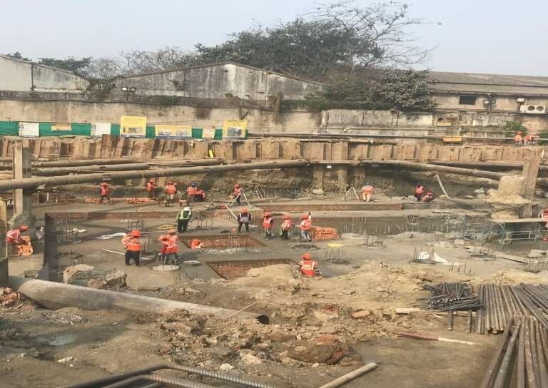 a group of people standing around a construction site
