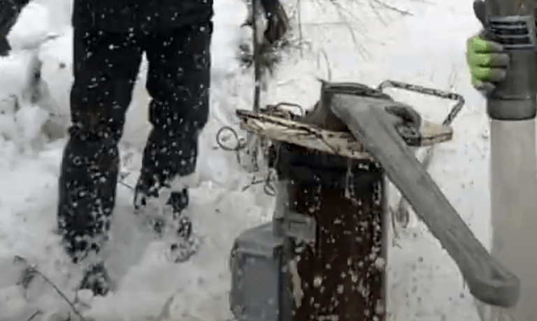 Large wrench opening well head in winter.
