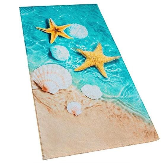 a beach towel with shells and starfishs on it