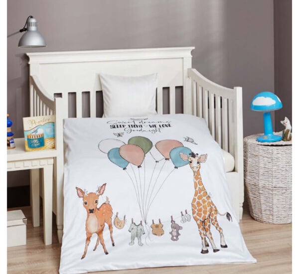 a baby's bed with a baby's bedding and a baby '