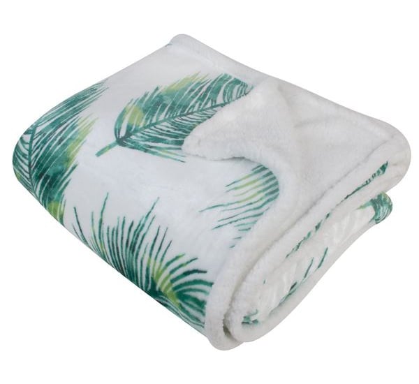 a white blanket with a green palm tree print