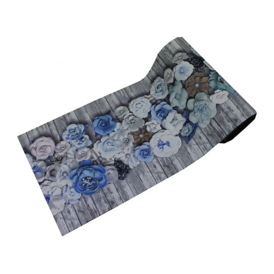 a roll of fabric with blue flowers on a wooden table