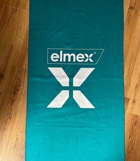 a towel on a wooden floor with a logo on it