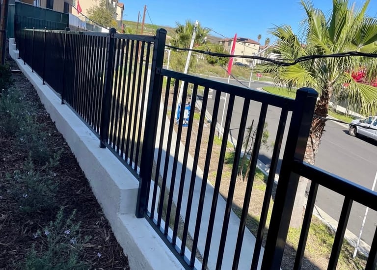 Wrought iron fencing in top of block wall.
