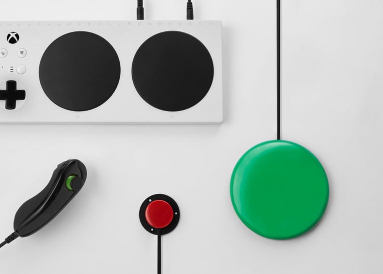 Xbox adaptive controller, a while rectangle with 2 large buttons, and additional accessories