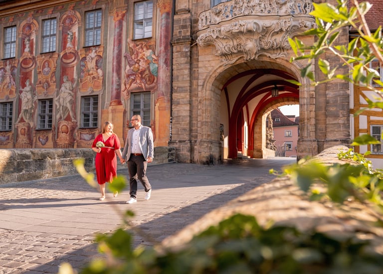 a man and woman walking down a cobblestone path