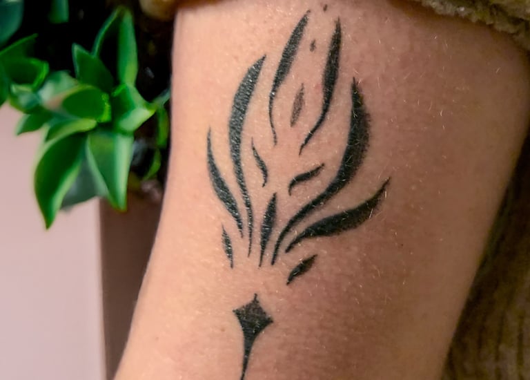 a tattoo style ornamentation tattoo on a woman's arm