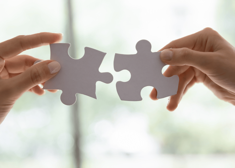 image of someone putting the pieces of a puzzle together