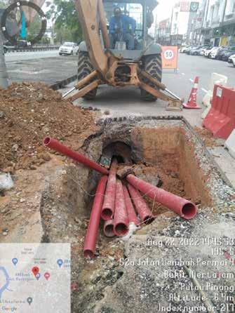 a construction worker is working on a hole in the ground