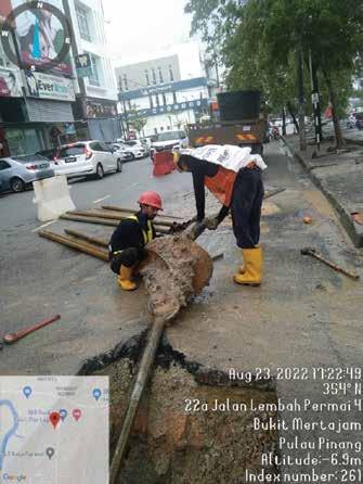 a man and woman working on a street