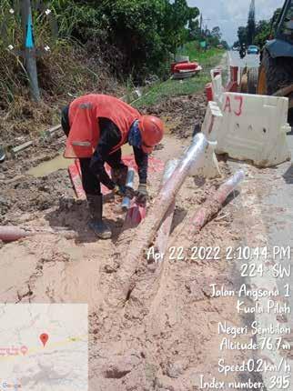 a man in a red shirt is working on a construction site