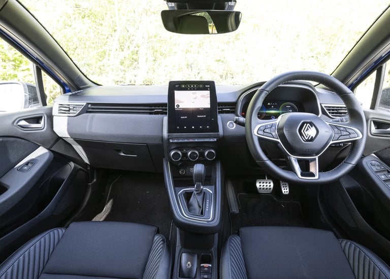 a car dashboard with a steering wheel and steering wheel