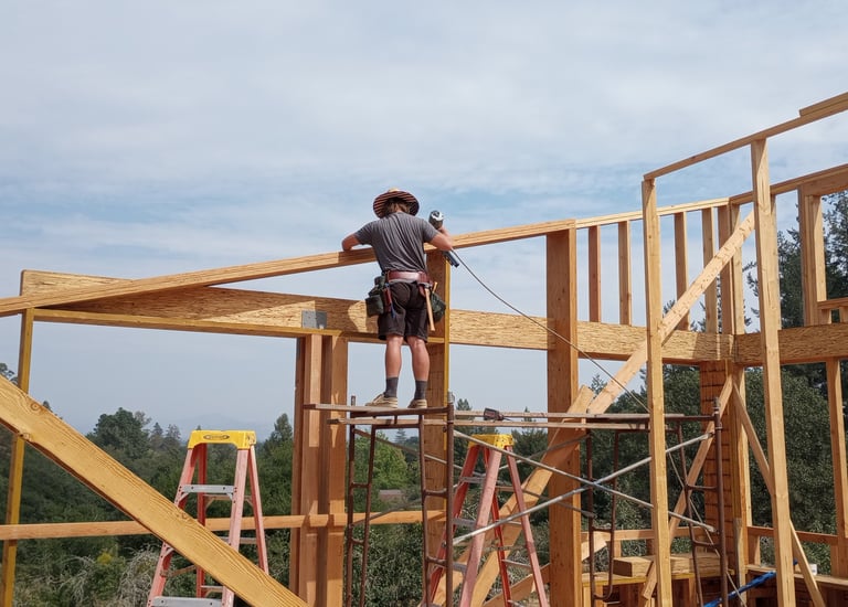 a man standing on a scaffold of wood beams