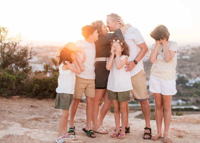 a family of four children and their parents in a family photo