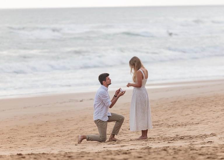 a man kneeling down to a woman who is kneeling down
