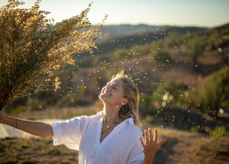 a woman holding a bunch of flowers in her hands