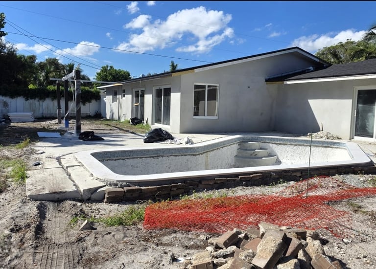 "General view of the backyard of a house with a pool under construction. 