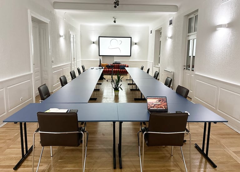 a conference room with a long table and chairs