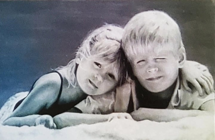 Siblings rendered in soft tones like a quiet chord of warmth and innocence