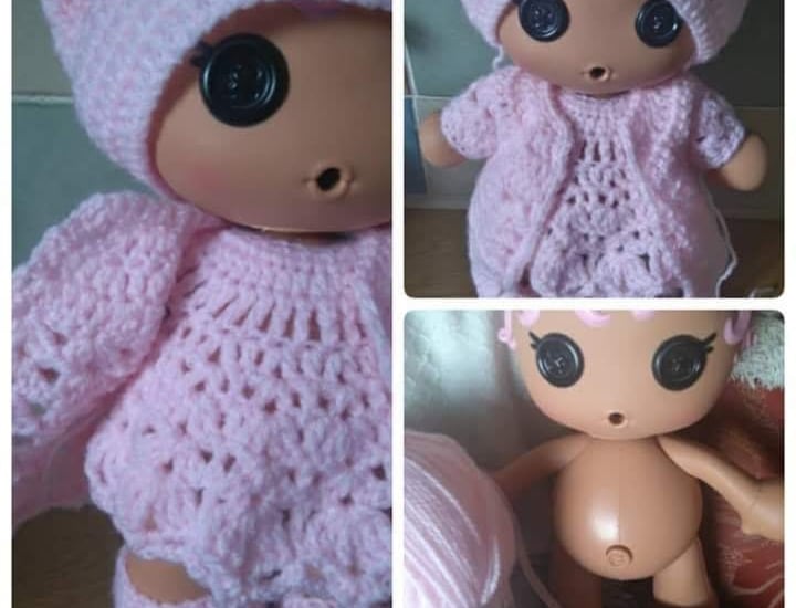 a doll doll with a pink crochet outfit and a pink hat made to measure