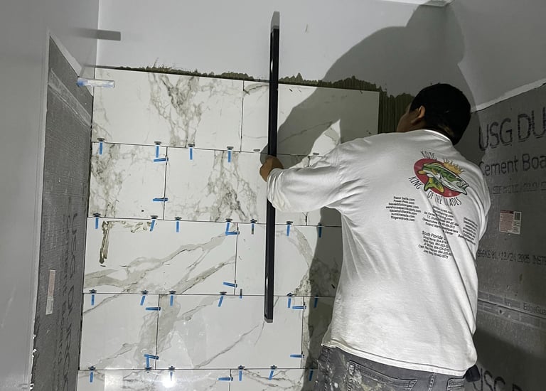 Professional working on a bathroom remodel installing marble