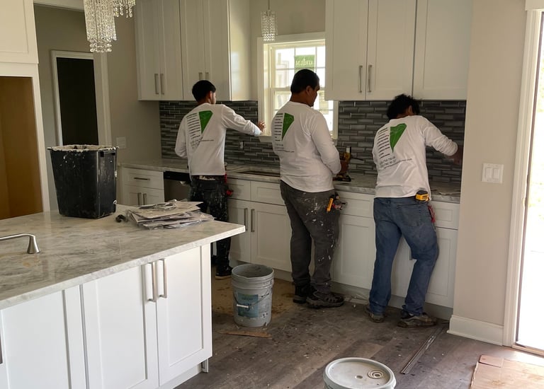 a group of people standing in a kitchen