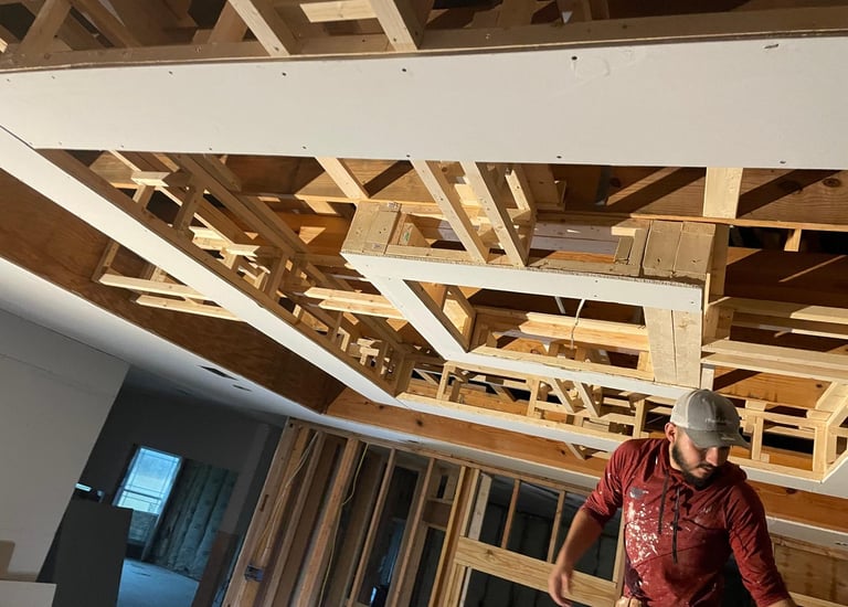 professional carpenter working on a wooden structure inside a room.