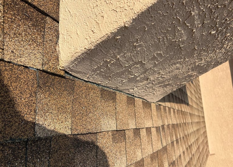 Damaged chimney flashing on an asphalt shingle roof, showing a common cause of water leaks, before repair by Roslyn Chimney