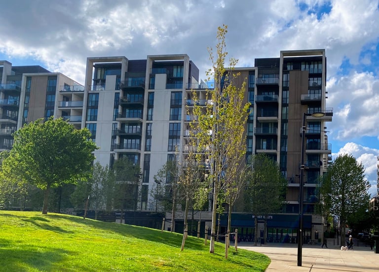 Blocks of flats with beautiful greens and trees. The beautiful blue sky contrasting th e environment