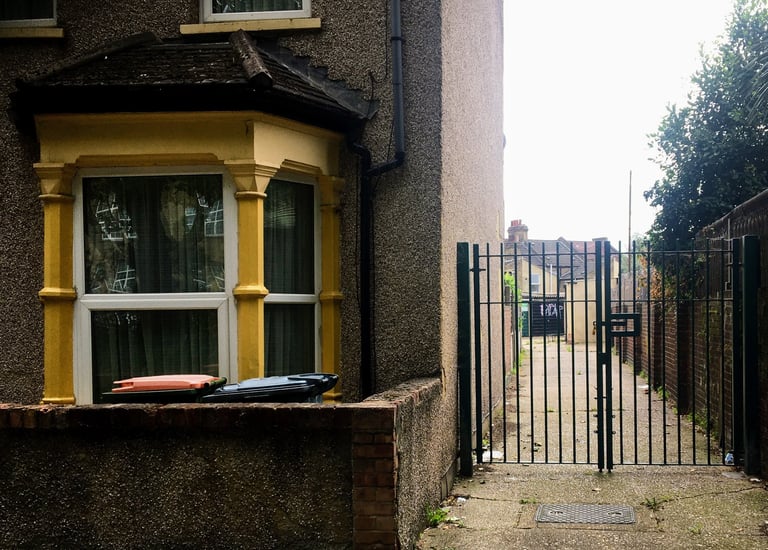 An end of terrace hous with yellow front and side entrance