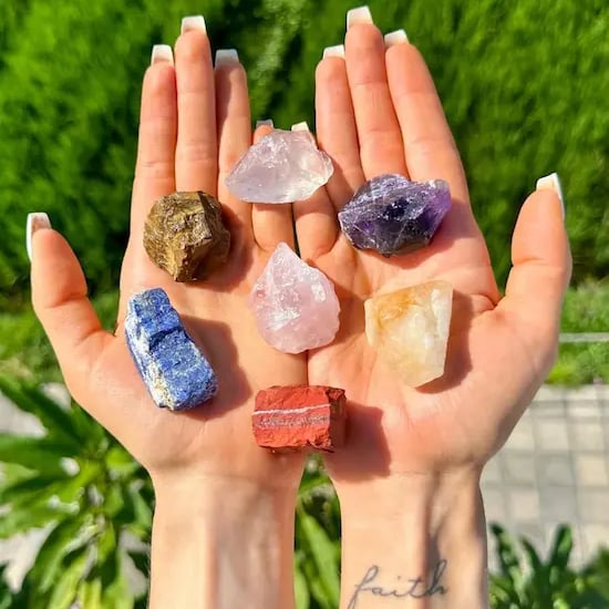 a person holding a bunch of crystals in their hands