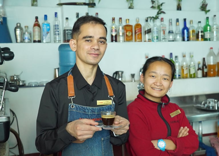 a man and woman standing in front of a bar