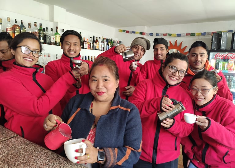 a group of baristas standing around a counter top