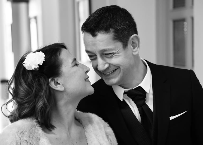 a man and woman are smiling and looking at each other