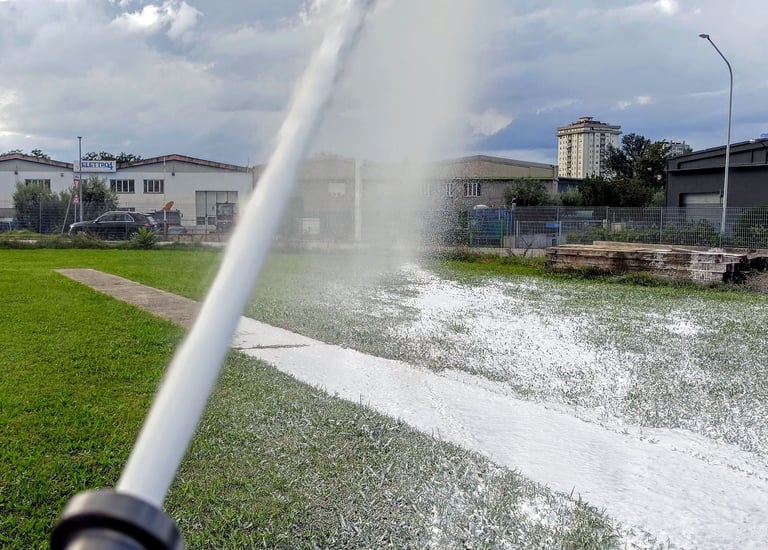a sprinkler sprinkler sprinkles foam in the grass