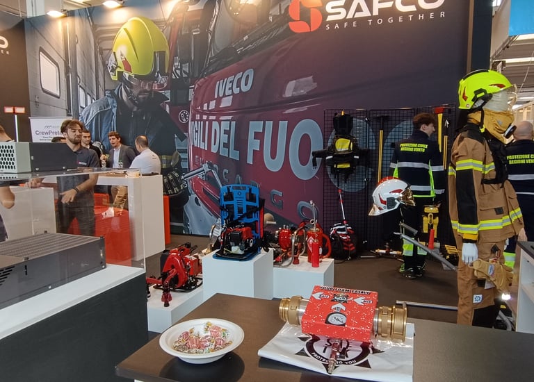 a group of people standing around a table with a laptop and Rafs the cafs foam generator