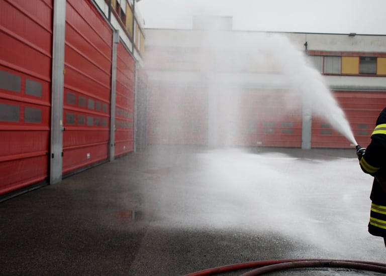 a firefighter is using a smoothbore nozzle to spray cafs type firefighting foam