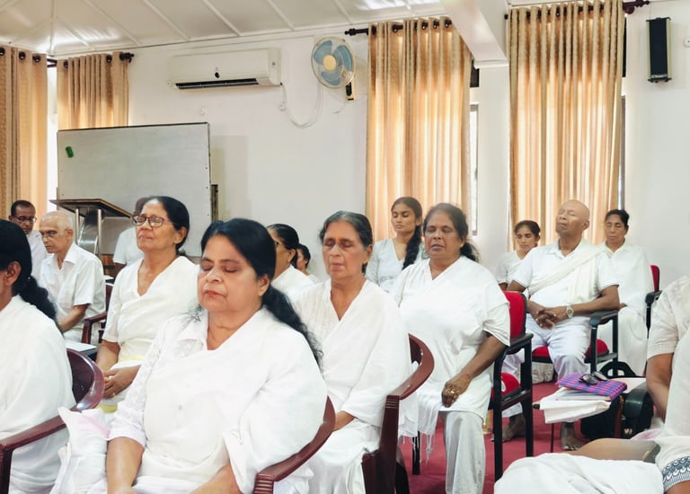 a group of people sitting in chairs in a room