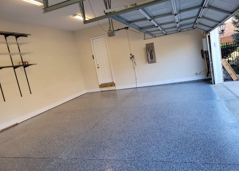 a garage with a garage door open and a garage door open