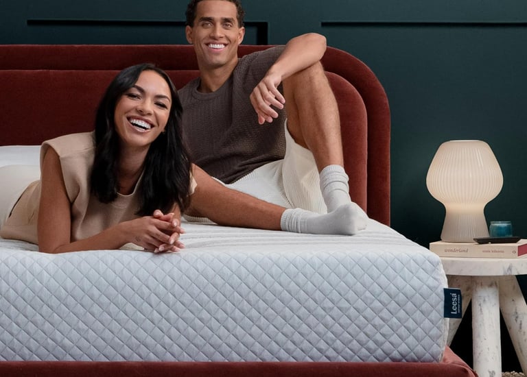 Couple lounging on a Leesa Sapira Hybrid Mattress