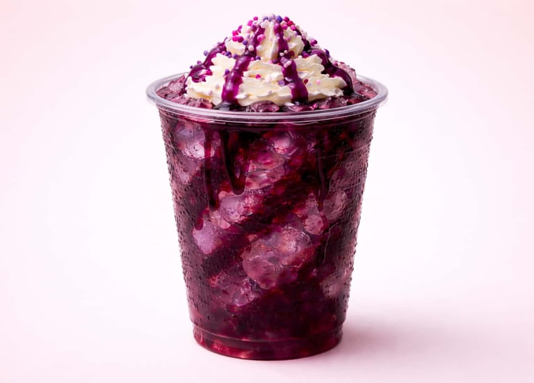 Purple berry flavor bomb dirty soda with crushed ice, whipped cream, and syrup drizzle