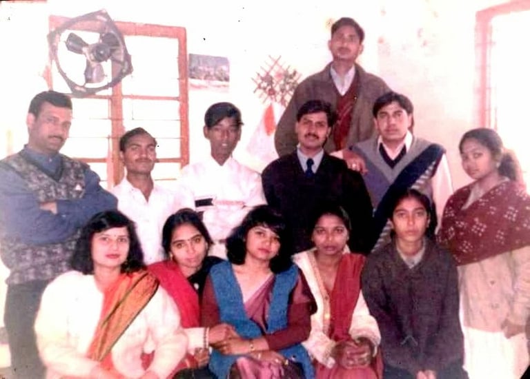 a group of people standing around a man in a suit and tie