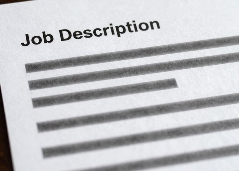 Close-up of hands collaborating over workplace documents filled with colorful notes.