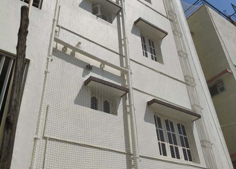 Outdoor AC unit wrapped with sturdy pigeon netting.