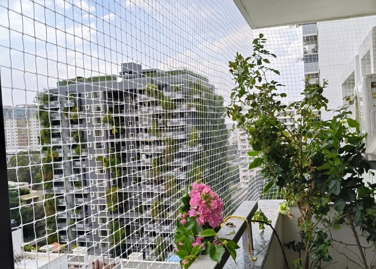Close-up of sturdy pigeon safety netting installed on a residential balcony in Guindy.