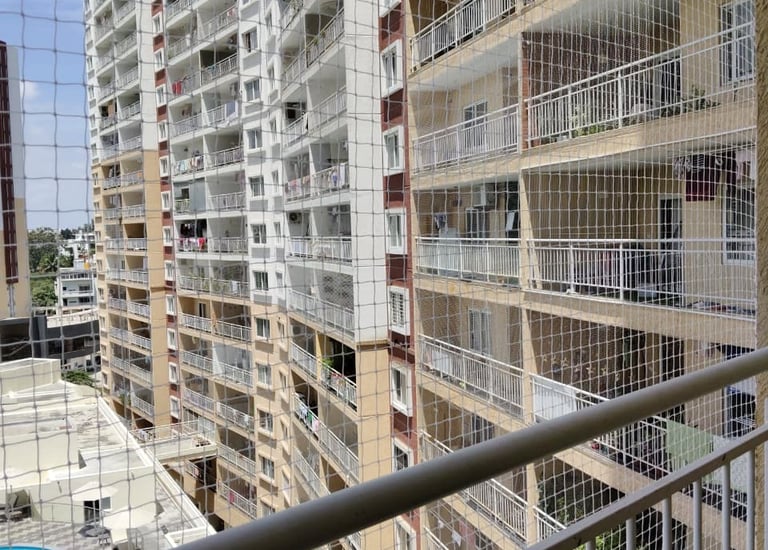 Finished balcony with clean, tight pigeon net protecting the space.