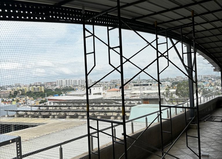 Installation team fitting pigeon nets around a commercial building.