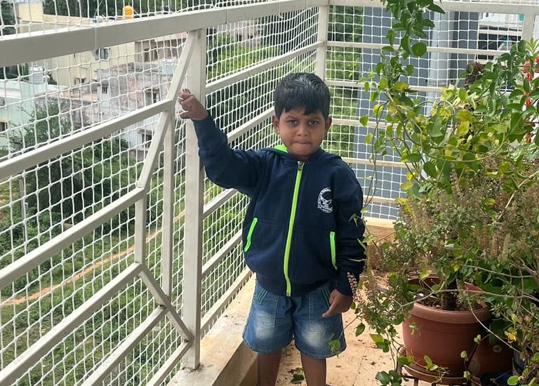 child-safe net installed on a window to prevent falls.