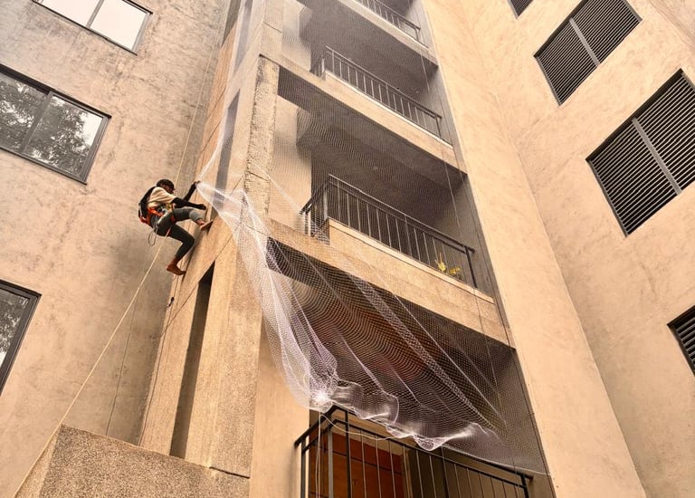 Wide shot of a high-rise building in Bombay fitted with pigeon safety nets.