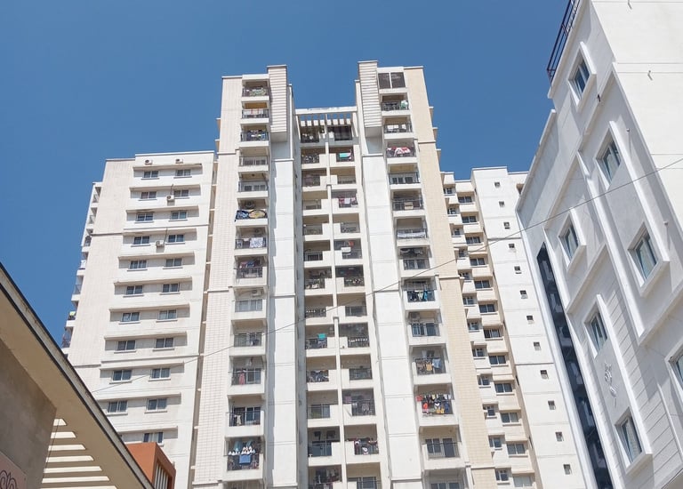 Wide shot showing multiple balconies fitted with safety nets in a Mumbai apartment.